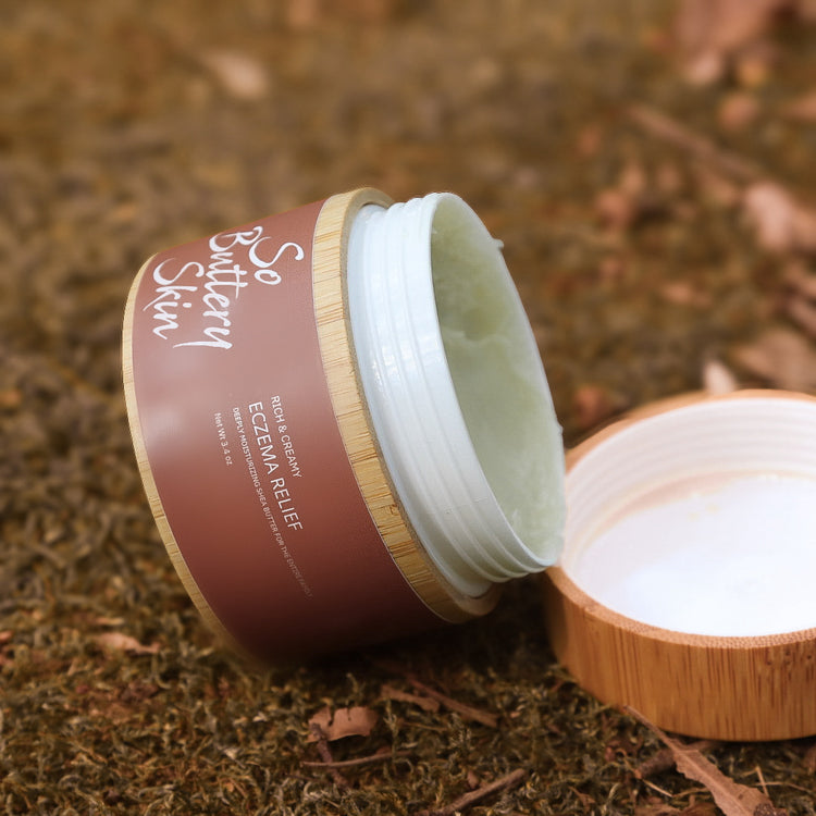 Whipped Eczema Relief Body Butter texture in an open 3.4oz travel jar, no steroids or synthetic fragrance