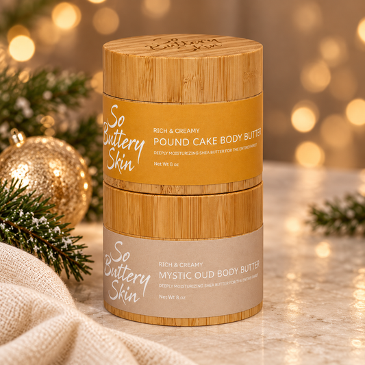 Luxe Holiday Oud Collection: Pound Cake jar stacked on Mystic Oud jar with a gold ornament