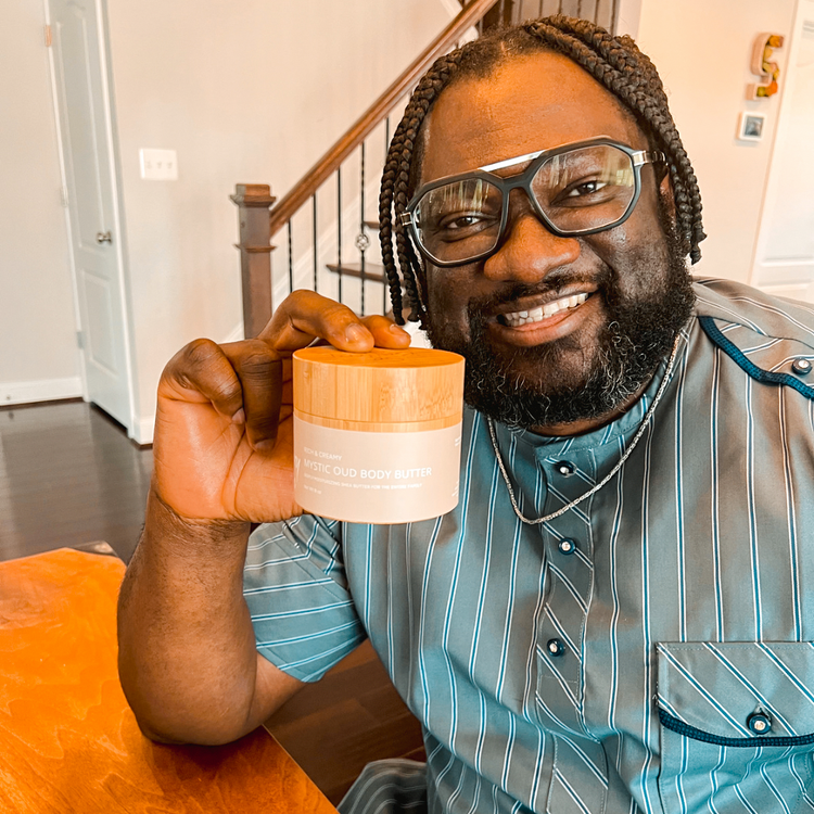 A man holding So Buttery Skin plant-based, chemical-free Mystic Oud Body Butter Jar