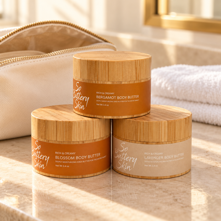 Travel size Body Butter Trio: Bergamot, Blossom and Lavender jars beside a canvas toiletry bag