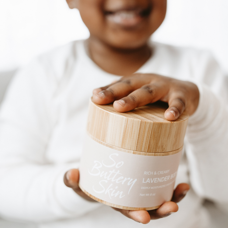 Little girl holding jar of So Buttery Skin Lavender Body Butter