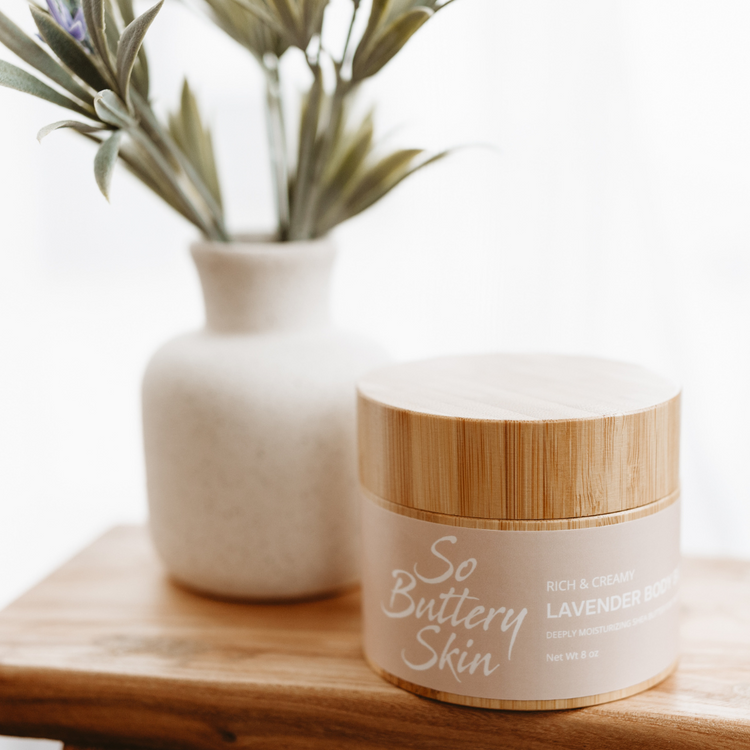 Jar of plant-based lavender body butter on a wooden tray