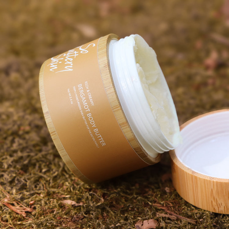 Bergamot Body Butter 3.4oz mini held in hand, carry-on skincare for dry sensitive skin