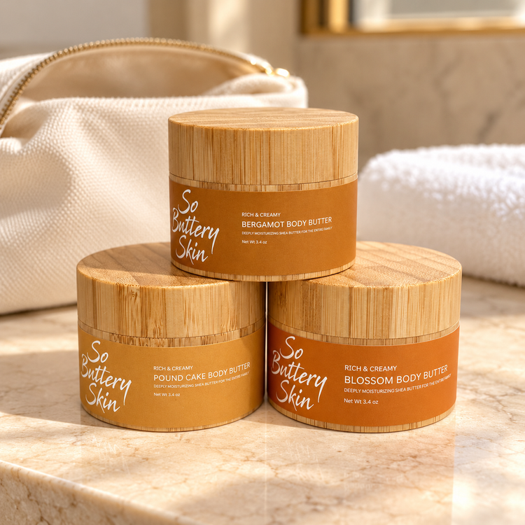 Travel size Body Butter Trio: Bergamot, Pound Cake and Blossom jars stacked on marble